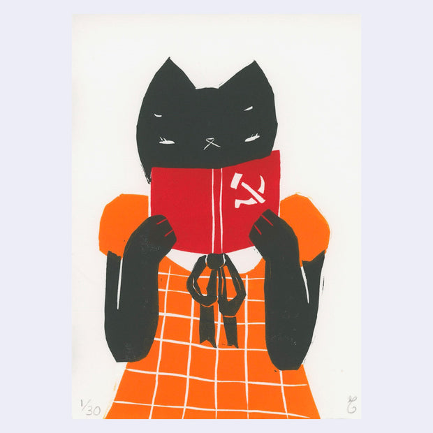 Print of a black cat, wearing an orange gingham dress and reading a red book with the communist logo on the cover.