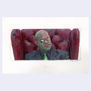 Person sitting on a red leather couch with a white background