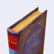 Corner view of a vintage looking hardcover book.