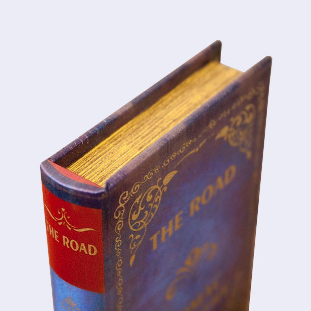 Corner view of a vintage looking hardcover book.