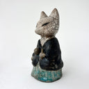Ceramic figurine of a fox wearing more traditional Japaneses clothing.