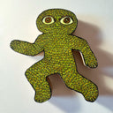 Die cut wooden sculpture with a flat back to hang on a wall of a leaf creature, in a running pose.
