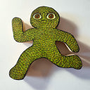 Die cut wooden sculpture with a flat back to hang on a wall of a leaf creature, in a running pose.