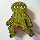 Die cut wooden sculpture with a flat back to hang on a wall of a leaf creature, in a running pose.