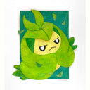 Cut paper artwork of a a green and yellow cartoon leaf character, with smaller leaves blowing off of them - on a teal background.