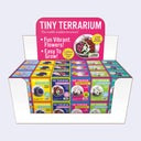 Display set up for 36 small terrariums that hold flower seeds, with 6 different varieties.