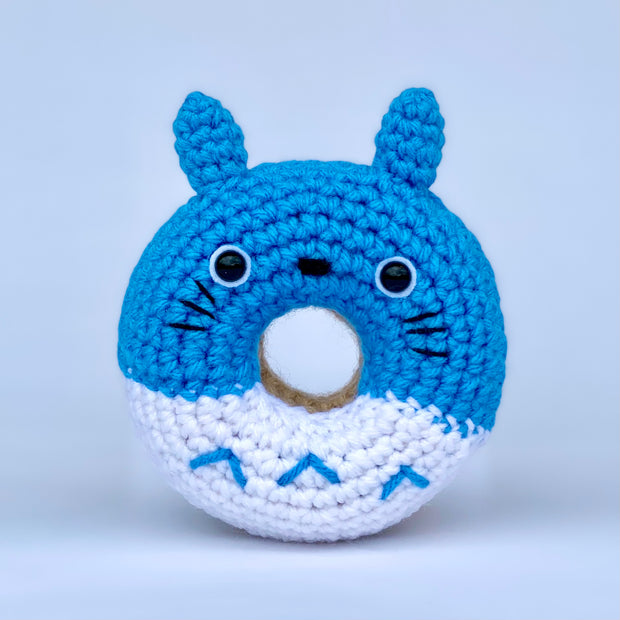A crocheted donut fashioned to look like blue Totoro.