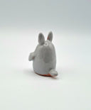 Small gray ceramic Totoro figurine on a white background