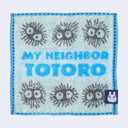 Small square towel, light blue with blue border. Text in center reads "My Neighbor Totoro" in blue and gray soot sprites are around the words.