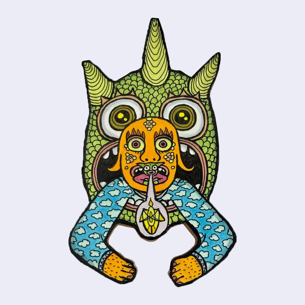 llustration made with many lines, giving it the feel of a folk art woodcut on a die cut wood panel of a character wearing a blue cloud sweater popping out of the mouth of a green reptile monster.