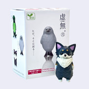 Small figurine of a black, fluffy Chihuahua standing in front of product packaging for Void Animals Blind Box (vol 2).