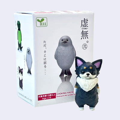 Small figurine of a black, fluffy Chihuahua standing in front of product packaging for Void Animals Blind Box (vol 2).