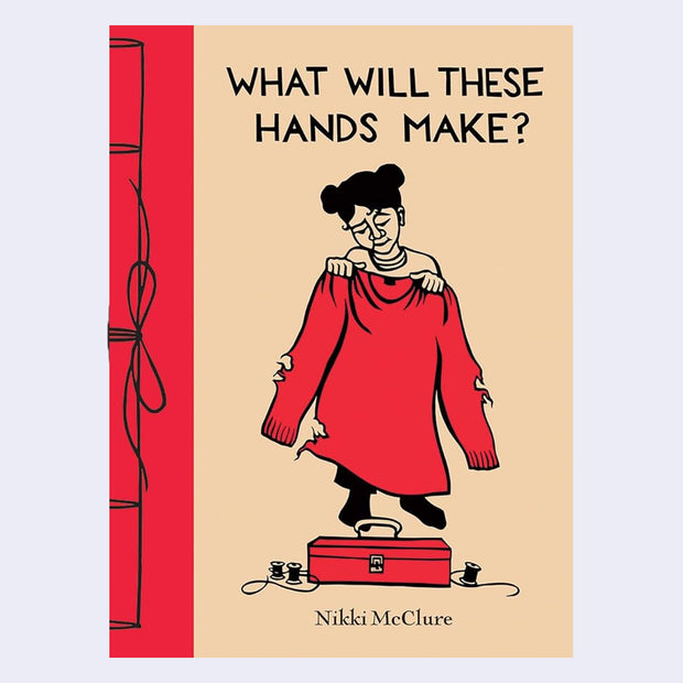 Children's book cover for "What Will These Hands Make?" with title and illustration of a girl holding a large red sweater with many holes in front of a sewing box.