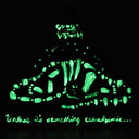 A black triangular sculpture featuring a glowing green glow-in-the-dark butterfly design with the text 'DO NOT DISTURB!' at the top and 'Unless it's something cataclysmic"