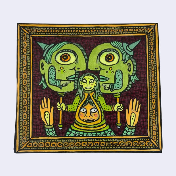 Illustration made with many lines, giving it the feel of a folk art woodcut on a rectangle wood panel of a person wearing a costume. A woman is atop his head, as part of his hat. The woman holds 2 large cutouts of goblin heads, facing one another and pointing at each other.