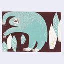 Rectangular fabric placemat with an illustration of a blue snow yeti, standing on its hind legs and bent to the side, as if in the middle of a side stretch. It stands near geometric rock shards.
