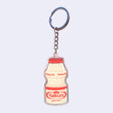 Die cut acrylic keychain of an illustrated bottle of Yakult with "giant robot" written small under the logo.