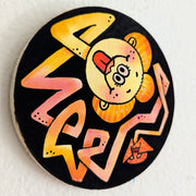 Painting on circular panel of a orange and red long line coming from a tiny kimono wearing body. The end of the line is a smiley face with the tongue out and a geisha's wig.