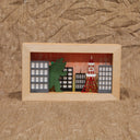 Shadow box depicting Godzilla in “Tokyo” at sunset. Battery operated light will illuminate the background imitating a sunset sky