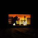 Shadow box depicting Godzilla in “Tokyo” at sunset. Battery operated light will illuminate the background imitating a sunset sky