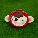 Ceramic sculpture of a cartoon style character's face in a tomato hood hat, with their winking face showing and their large, semi circle ears. They have rosy cheeks and short brown hair that shows out of the hat.