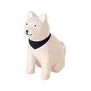 White dog figurine with a black scarf on a white background