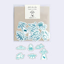 Set of alien-themed stickers on a beige card with a brand label.