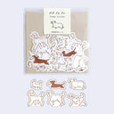 Flake stickers with dog illustrations on a beige card