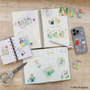 Journal spread with many stickers of animals in cute outfits and nature themes.