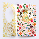 Birthday card with pink background and colorful flowers, revealing a cutely dressed cat.