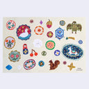 Postcard with many colorful buttons and charm illustrations on it.