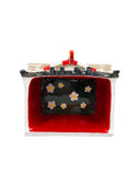 Ceramic sculpture of a model of Bob Baker Marionette Theater. Seen overhead with flowers on its floor.