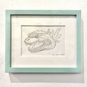 Refined graphite sketch drawing of a Godzilla head, with an open mouth and teeth showing. It's matted and in a mint colored frame.