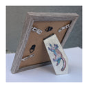 Back view of a photo frame, with a mini painting on the stand of a raccoon.