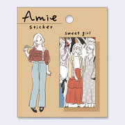 Amie sticker packaging with illustrations of a girl and a group of girls on a beige background.