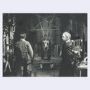 Black and white illustration of three figures in a room with a large cross on the wall.