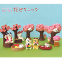 Set of cat-themed figurines with cherry blossom trees on a blue and green background