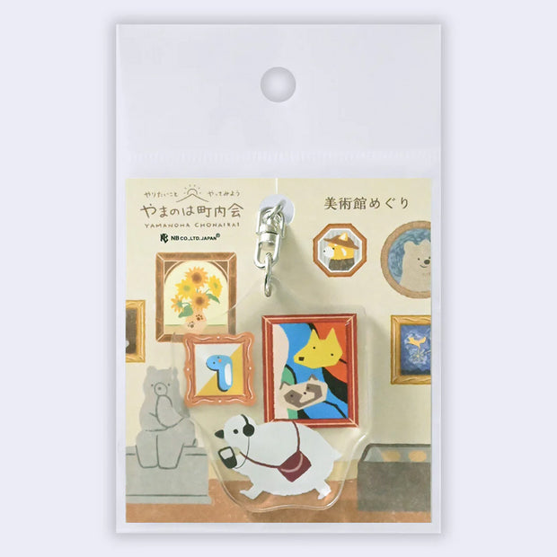 Decorative keychain with cartoon characters in a gallery setting on a white background