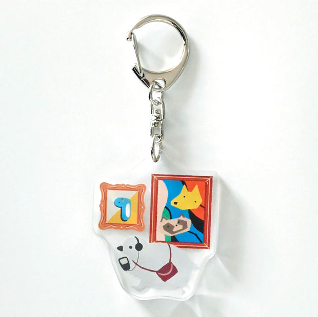 Keychain with cartoon character and framed images on a white background
