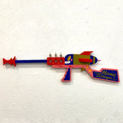 Colorful toy gun labeled 'Atomic Stinger' on a white background