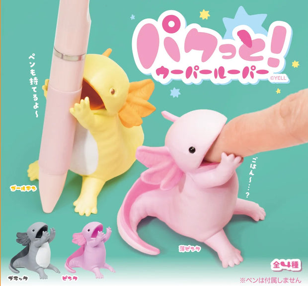 4 axolotl figurings, sitting with their hands in front of their open mouth, with space in between to hold a pen. Color options are: yellow, pink, purple and gray.