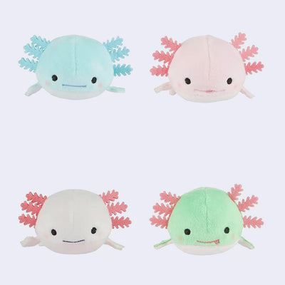 Four plush axolotl toys in different colors on a light blue background