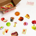 Glittery display of stickers themed around apples, the fruit itself and apple adjacent foods and pastries.