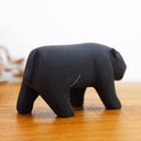 Wooden figurine of a black panther, with a growling expression.