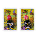 Two clay magnets of Badtz Maru, one is holding a small sword and the other is holding a small knife, each in its own plastic packaging with a colorful backing. 