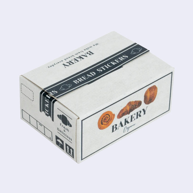 Box of stickers, made to look like a cardboard shipping box holding bakery bread, with labeling and illustrations on the exterior that mimic the real thing.