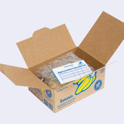 Open box of miniature stickers, made to resemble a shipping box with bubble wrap around the product and a small invoice. Exterior of box looks like realistic banana produce box.