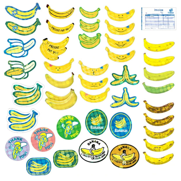 Lineup of approximately 40 banana themed flake stickers, all with a slight holographic shine. Bananas are either realistic depictions, cartoons, or look like fruit label stickers.