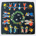 A square black scarf featuring a colorful folk-art style illustration of children, baskets, flowers, and a wreath, with the brand name 'Harasa' in the bottom-left corner.