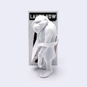 White monkey figurine with a 'Laugh Now' box on a light gray background